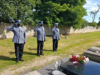 Komendant Powiatowy Policji w Kutnie wraz z dwoma innymi policjantami oddają honor przy grobie poległego policjanta