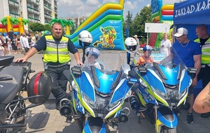 dzieci siedzące na motocyklach policyjnych.