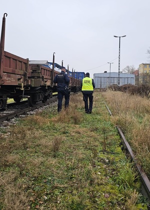 policjant z funkcjonariuszem Straży Ochrony Kolei partolują rejon kolei.